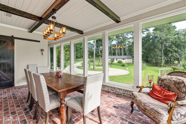 sunroom / solarium with beamed ceiling, a barn door, and an inviting chandelier