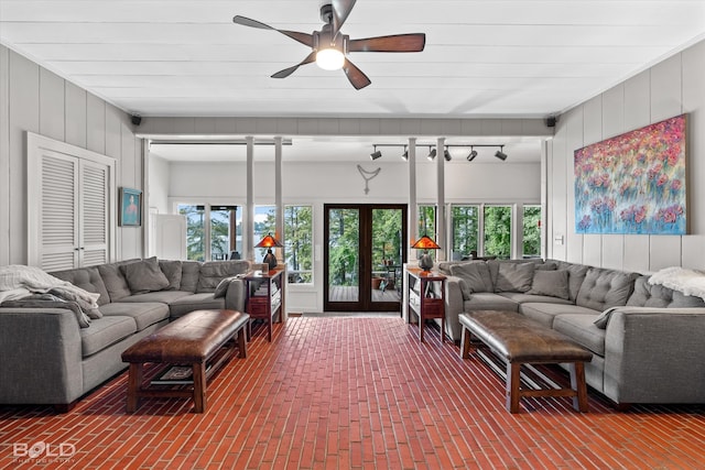 living room with french doors, plenty of natural light, and ceiling fan