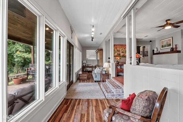 sunroom / solarium featuring track lighting