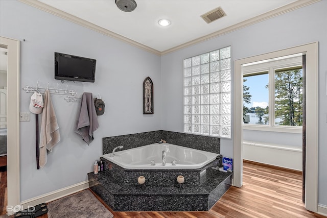 bathroom with crown molding, a bathtub, and hardwood / wood-style floors