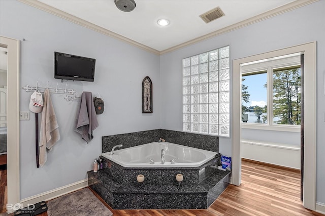 full bath with baseboards, visible vents, wood finished floors, crown molding, and a bath