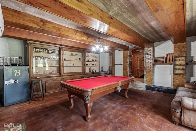 playroom with billiards, wooden ceiling, brick wall, concrete floors, and beam ceiling