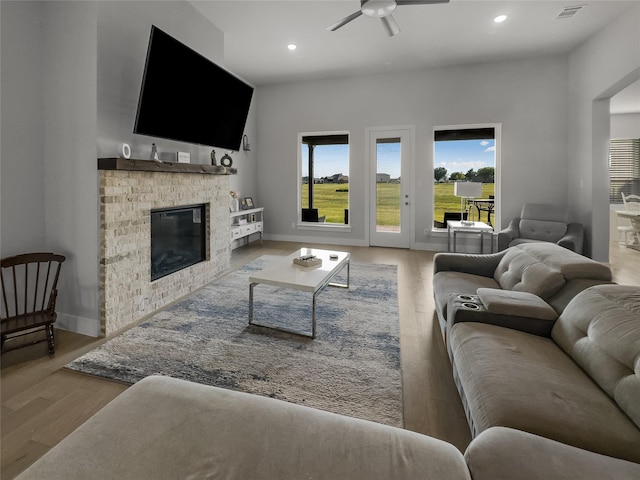 living area with light wood finished floors, a fireplace, visible vents, and recessed lighting