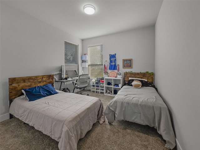 carpeted bedroom featuring baseboards