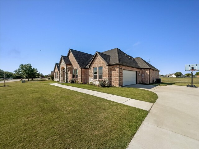 view of front of home with a garage and a front lawn