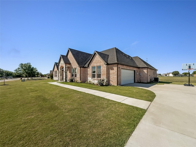 view of front of property with an attached garage, a front lawn, concrete driveway, and brick siding