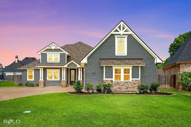 craftsman-style home with a lawn