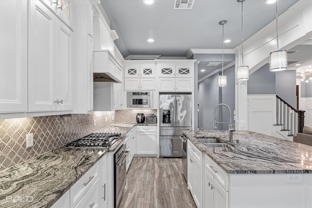 kitchen featuring custom exhaust hood, crown molding, hardwood / wood-style flooring, stainless steel appliances, and sink