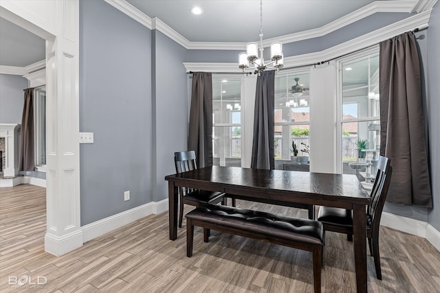 dining room with a notable chandelier, ornamental molding, and light hardwood / wood-style floors