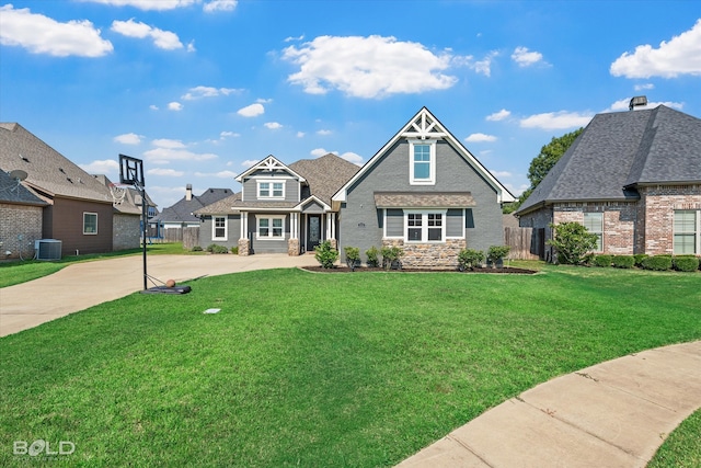 craftsman inspired home featuring central air condition unit and a front lawn