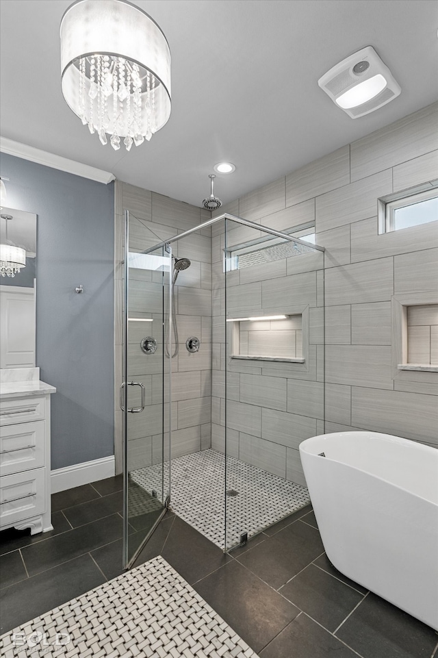 bathroom featuring tile walls, separate shower and tub, tile patterned floors, a chandelier, and vanity