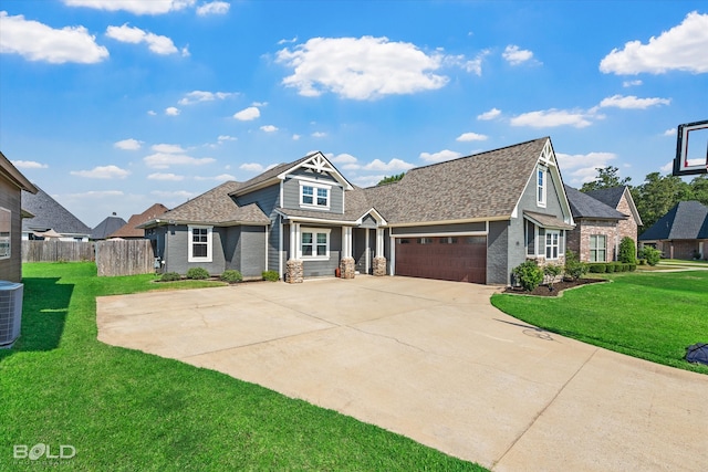 craftsman inspired home featuring central AC unit, a front yard, and a garage