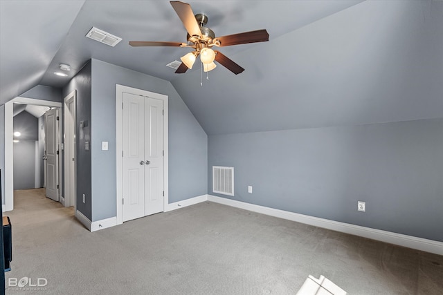 additional living space featuring ceiling fan, light carpet, and vaulted ceiling