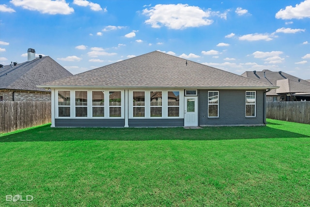 back of house with a lawn