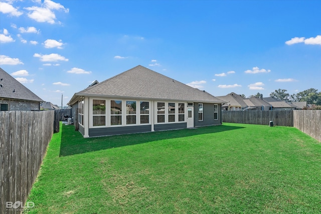 rear view of house featuring a yard