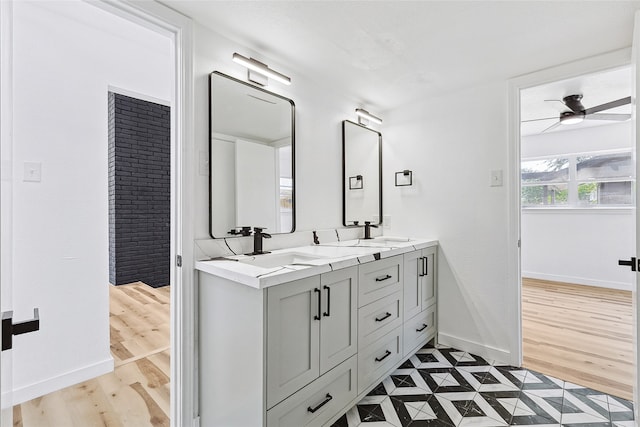 bathroom featuring wood-type flooring, vanity, and ceiling fan