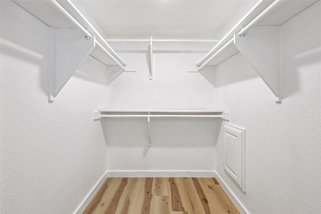 walk in closet featuring hardwood / wood-style floors