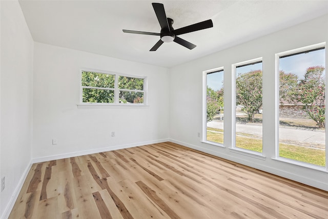 empty room with ceiling fan and light wood-type flooring