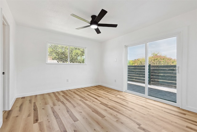 empty room with ceiling fan, a textured ceiling, and light hardwood / wood-style flooring