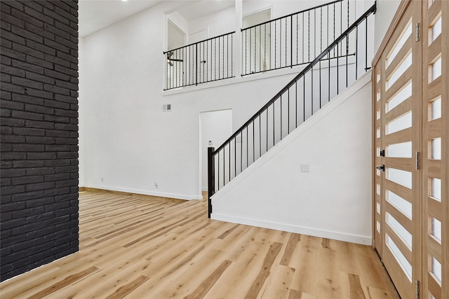 interior space featuring a high ceiling and light hardwood / wood-style floors