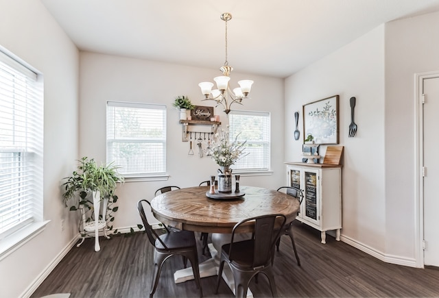 dining space featuring dark hardwood / wood-style floors, plenty of natural light, and a chandelier