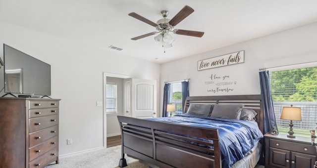 bedroom featuring ceiling fan and light carpet