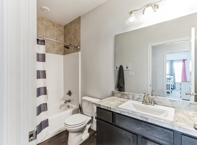 full bathroom with shower / tub combo, vanity, toilet, and hardwood / wood-style flooring