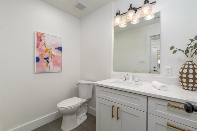 bathroom featuring vanity, tile patterned flooring, and toilet