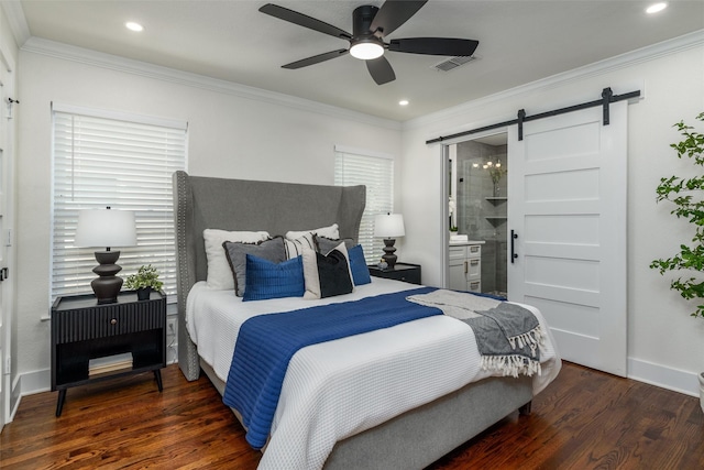 bedroom featuring dark hardwood / wood-style flooring, ornamental molding, and a barn door