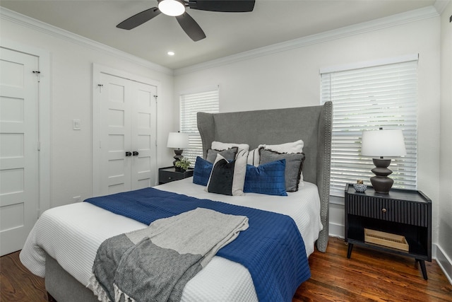 bedroom with dark wood-type flooring, crown molding, and multiple windows