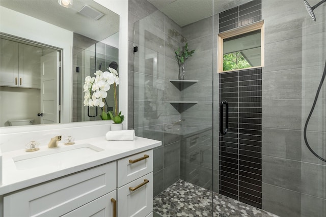 bathroom featuring vanity, toilet, and a shower with door