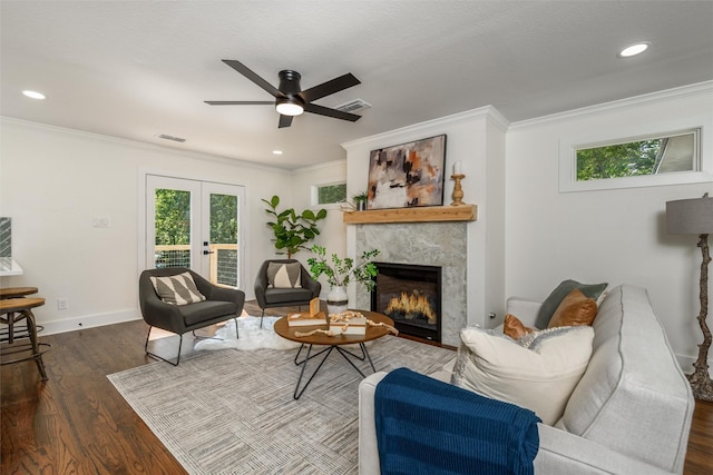 living room with crown molding, plenty of natural light, and french doors