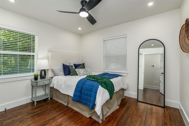 bedroom with dark hardwood / wood-style floors and ceiling fan