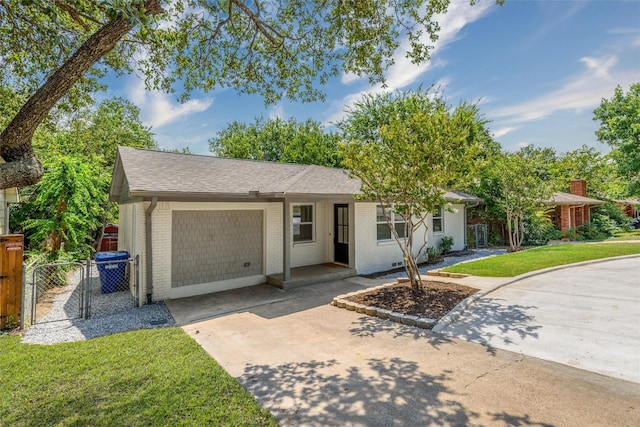 ranch-style house with a garage and a front lawn