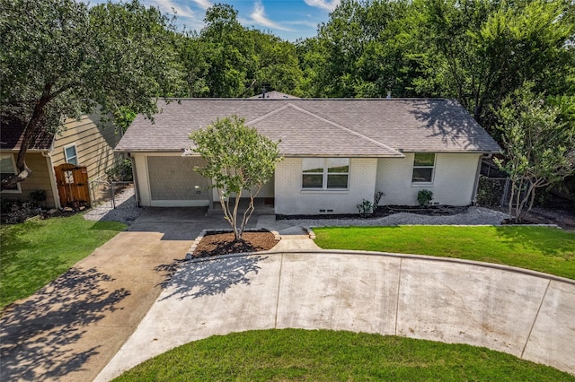 ranch-style home featuring a garage and a front lawn