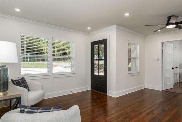 foyer entrance with dark hardwood / wood-style flooring, crown molding, and ceiling fan