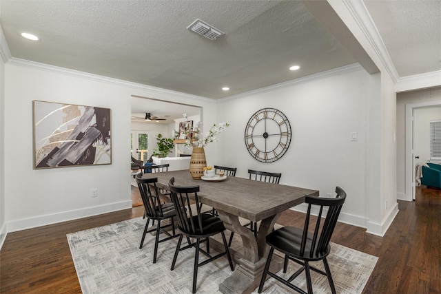 dining area featuring crown molding, dark wood-type flooring, ceiling fan, and a textured ceiling