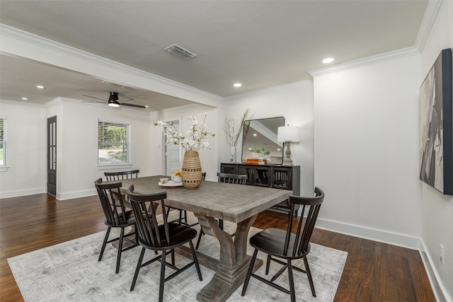 dining area with dark hardwood / wood-style flooring and ornamental molding