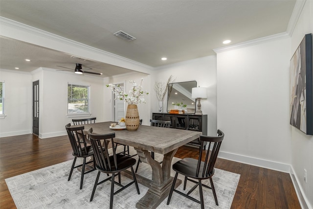 dining room with dark wood-type flooring, ceiling fan, ornamental molding, and a textured ceiling