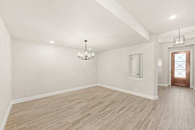 entrance foyer featuring a chandelier and light wood-type flooring