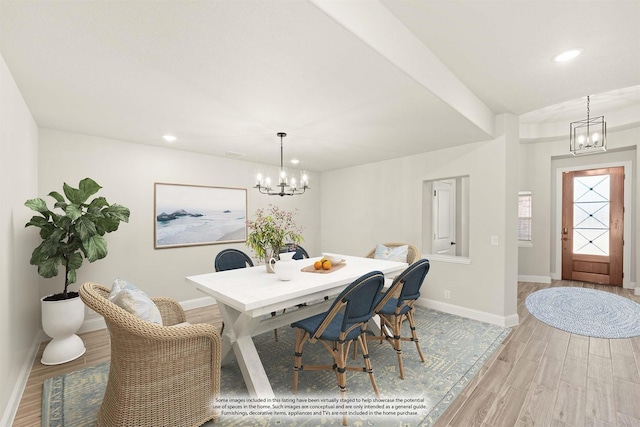 dining room featuring light hardwood / wood-style flooring and a notable chandelier