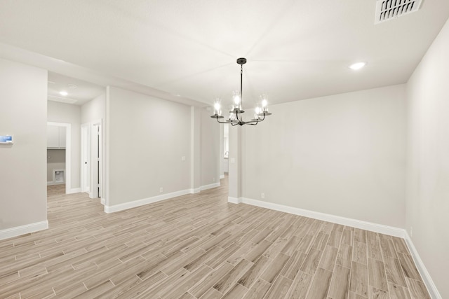 interior space with an inviting chandelier and light hardwood / wood-style floors