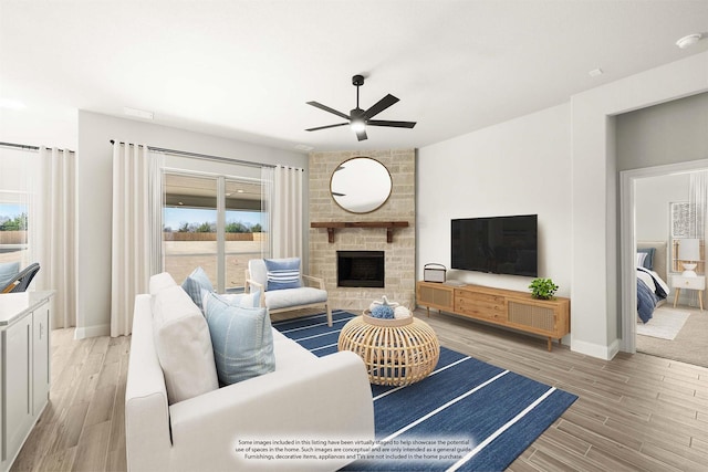 living room featuring a healthy amount of sunlight, a fireplace, and light hardwood / wood-style floors