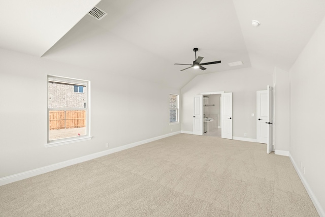 carpeted empty room featuring ceiling fan and vaulted ceiling