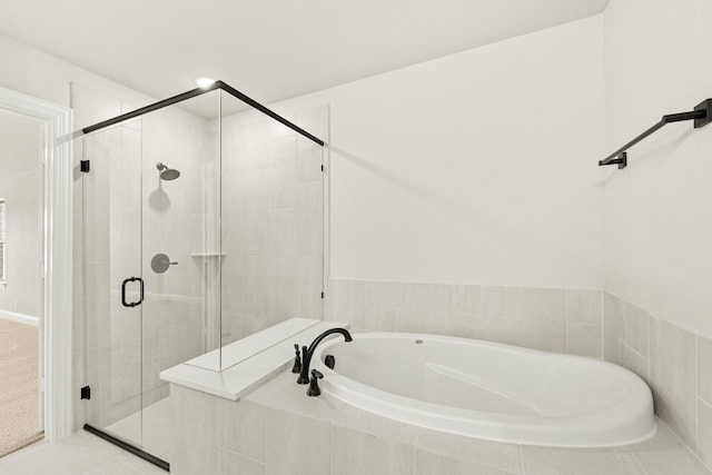 bathroom with shower with separate bathtub and tile patterned floors