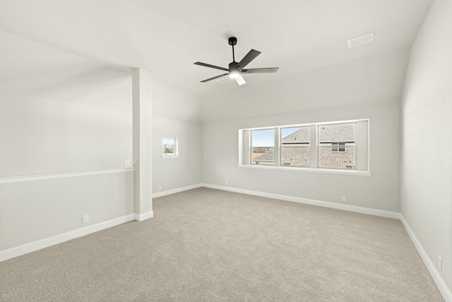 carpeted spare room featuring ceiling fan