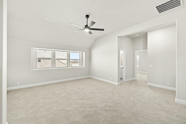 carpeted empty room with lofted ceiling and ceiling fan