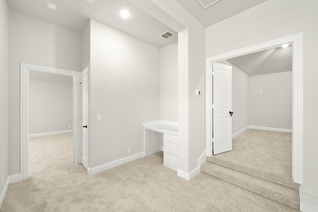 hall featuring light colored carpet