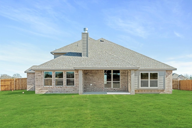 rear view of property featuring a lawn