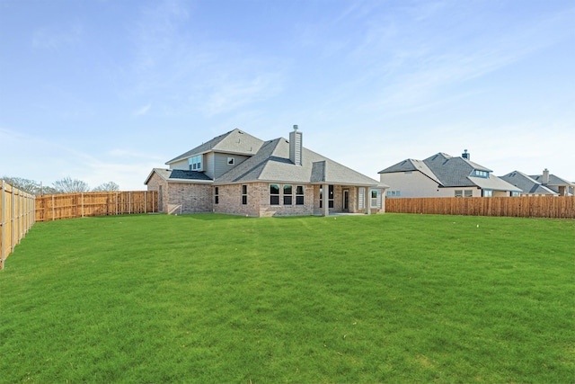 rear view of house featuring a lawn